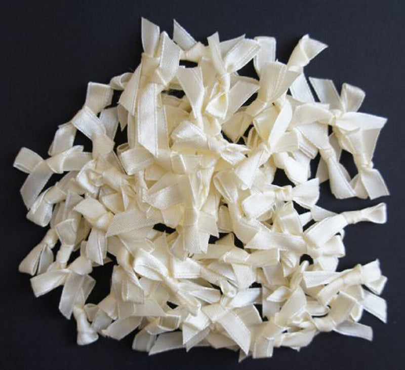 Pack of small decorative cream ribbon bow trims