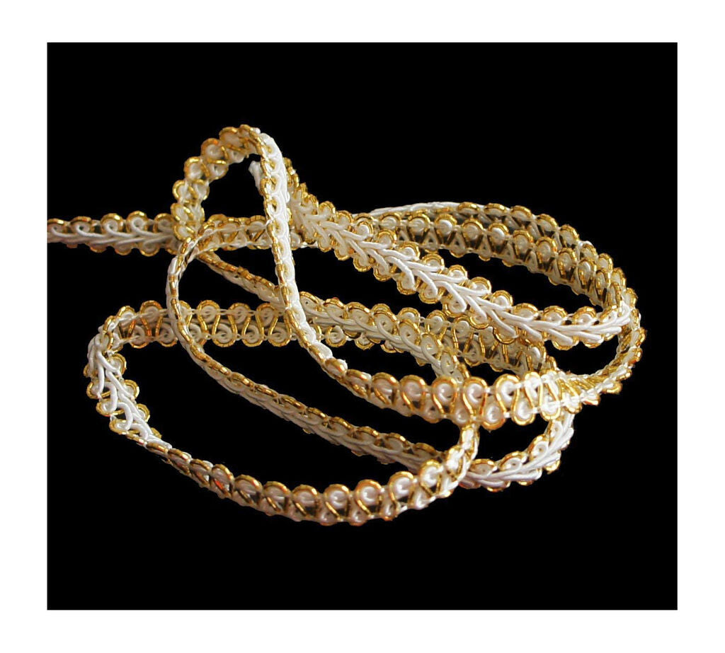 Close-up of white and gold ribbon trim, 8 mm wide.