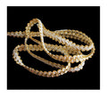Close-up of white and gold ribbon trim, 8 mm wide.