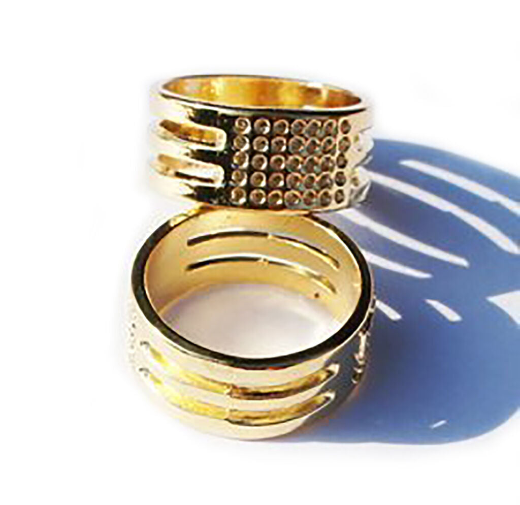 Two gold ring thimbles displayed on a white background.