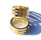 Two gold ring thimbles displayed on a white background.