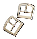 Polished silver tone belt buckles displayed on a white background.
