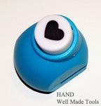 Heart shape craft paper punch on a wooden table
