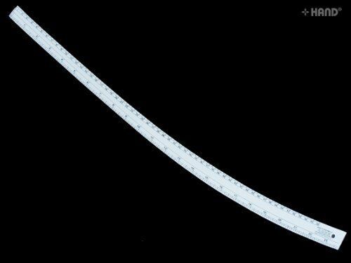 White metric curve ruler measuring 56cm on a flat surface.