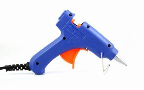 A person using a mini glue gun for crafting.