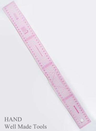 Ruler being used to grade a clothing pattern on paper