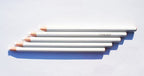 Close-up of a white wax china marker pencil showing its tip.