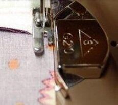 Close-up of the magnetic seam guide showing its compact size