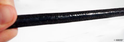 Application of black gel stop tape on bra straps.