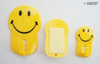 Self adhesive hooks displayed in a bathroom setting, holding lightweight items.