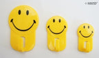 Close-up of a smiley face self adhesive hook showing its strong adhesive backing.