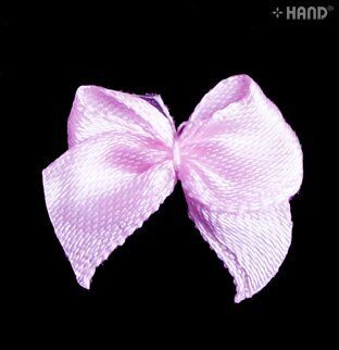 Close-up of a pink ribbon bow trim for crafts