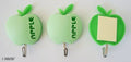 Three green apple shape self-adhesive hooks on a white background