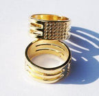 Close-up of a gold ring thimble showing its smooth surface.