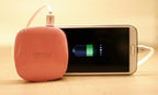 Power bank charging a mobile phone on a table