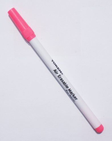 Two bright pink fabric marker pens on a white background.
