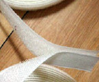 White Velcro stick on tape displayed on a craft table.