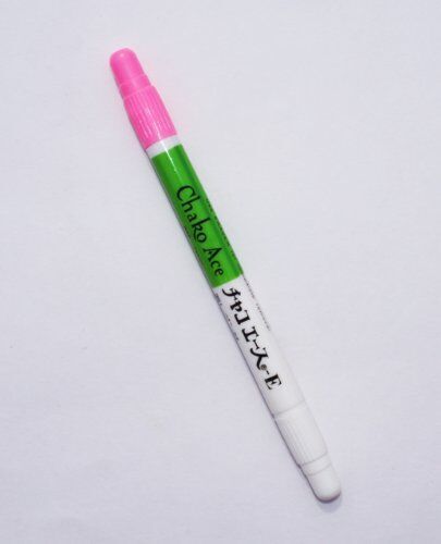 Close-up of the bright pink fabric marker pen showing its fine tip.