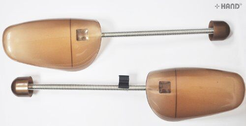 Shoe expanders displayed on a wooden surface