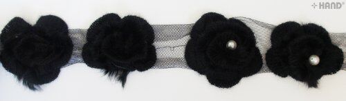 Close-up of decorative black knitted roses net trim