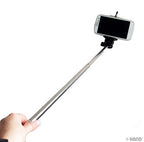 User demonstrating the monopod in a scenic outdoor setting.