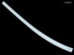 White curve ruler placed next to fabric for sewing reference.