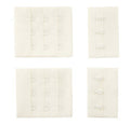 Close-up of white bra hook and eye fasteners with 3 hooks
