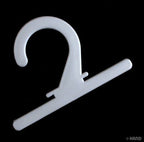 Multiple white plastic hangers arranged for display.