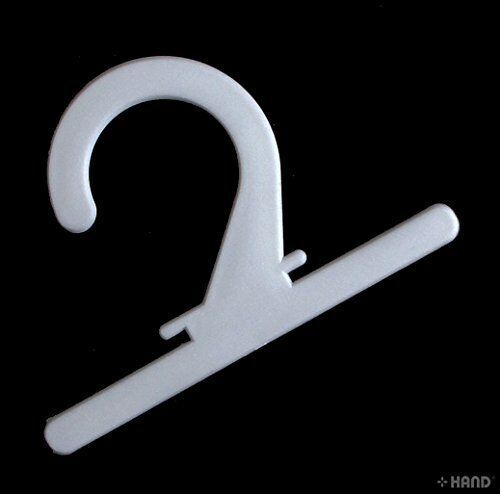 Multiple white plastic hangers arranged for display.