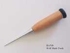 Awl being used to pierce through leather material.