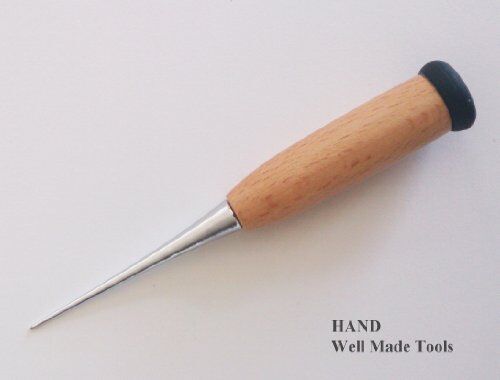 Awl being used to pierce through leather material.