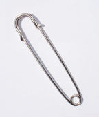 Close-up of a single extra large silver kilt pin measuring 102 mm.
