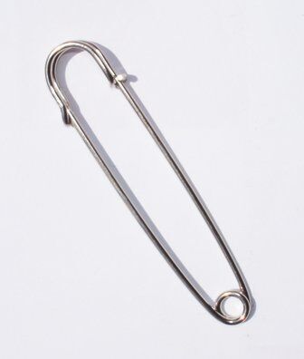 Close-up of a single extra large silver kilt pin measuring 102 mm.