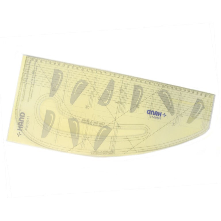 Pattern marking ruler in use by a student tailoring a garment.
