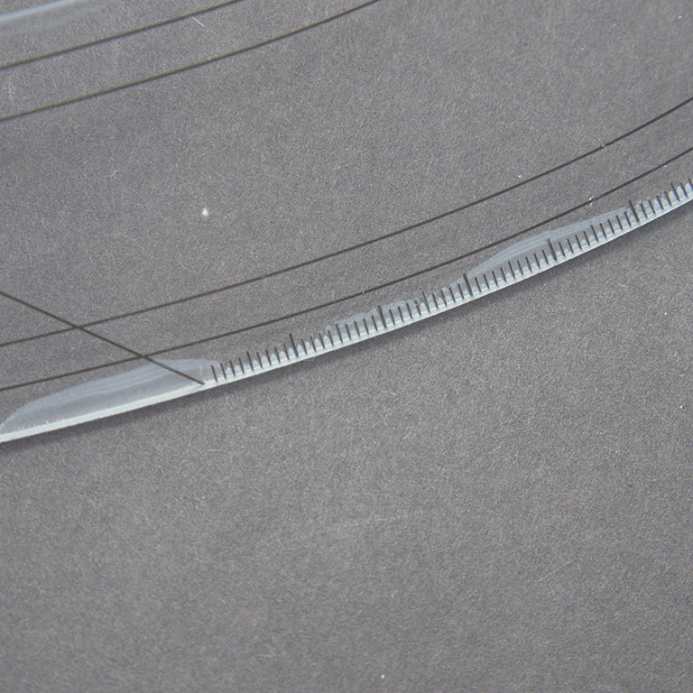 Ruler with visible bubbles and glue marks but fully functional.
