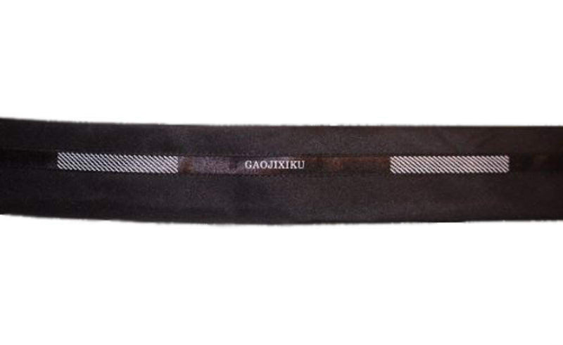 Black and white tailor waist band trim displayed on a roll.
