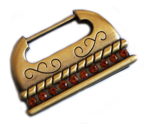 Vintage gold tone metal handbag buckle with orange rhinestones.