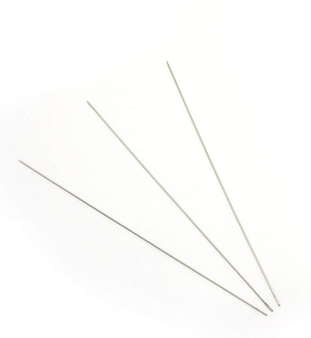 Three extra thin beading sewing needles on a white background.