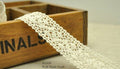 Natural cream cotton lace trim, 25mm wide on a spool.