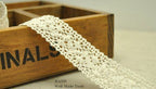 Natural cream cotton lace trim, 25mm wide on a spool.