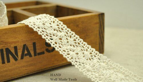 Natural cream cotton lace trim, 25mm wide on a spool.
