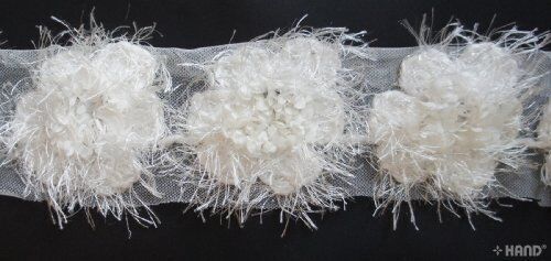 Close-up of decorative white angel flower net trim