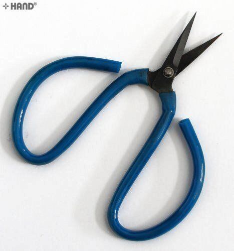 Heavy duty scissors in hand, demonstrating their use