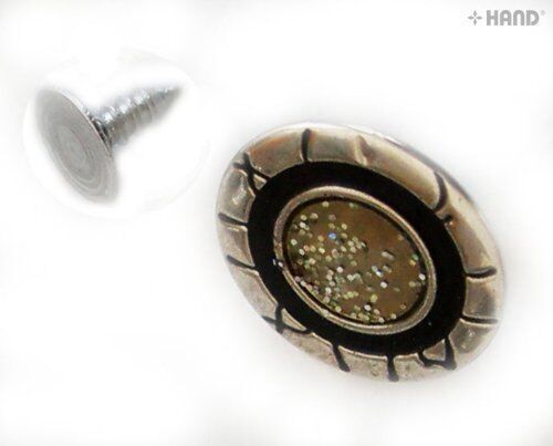 Close-up of a glittery jeans button showcasing its shiny finish.