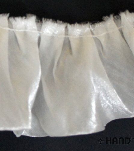 Frill trim in use on a fabric project, showcasing its elegance.