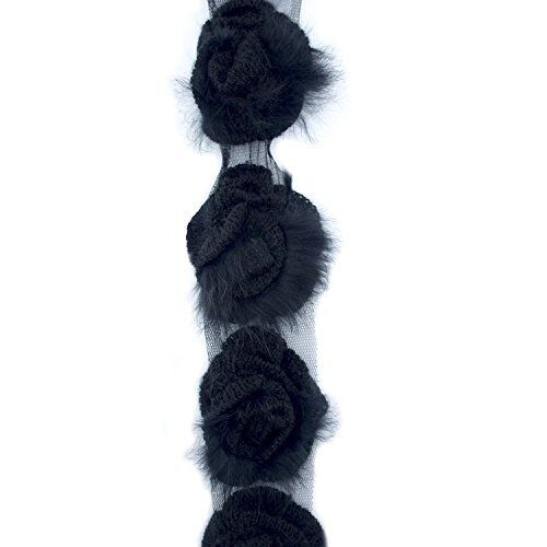Close-up of black knitted rosettes with fluffy fringes.