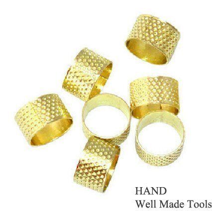 Two gold ring thimbles displayed on a white background.