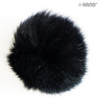Close-up view of a black rabbit bobble ball trim showing texture
