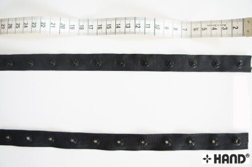 Roll of 10 metres push button tape, 18mm wide, in black.
