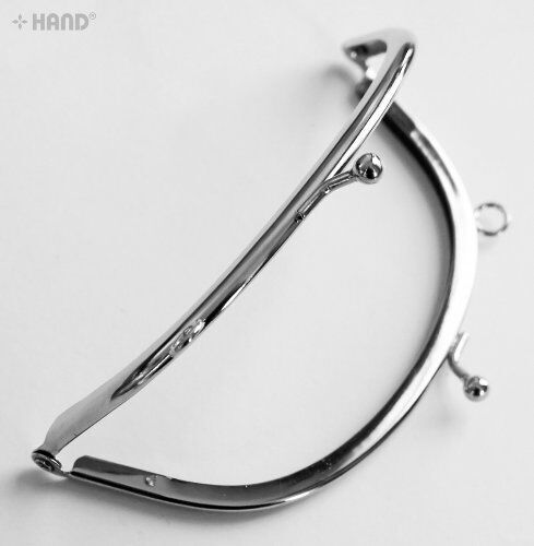 Close-up of the small balls kiss clasp on the purse frame.